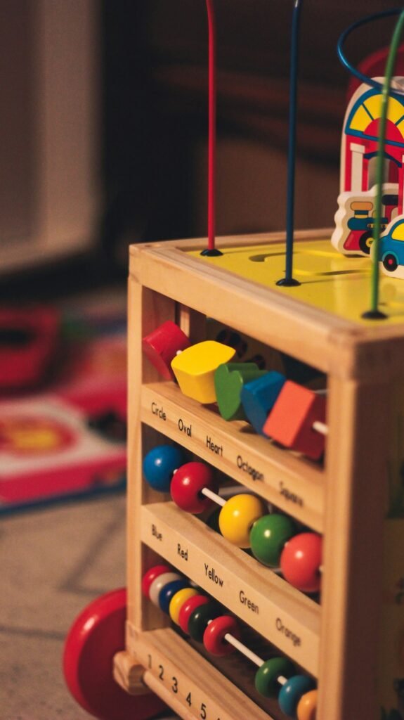 Child playing with a colourful wooden stacking toy